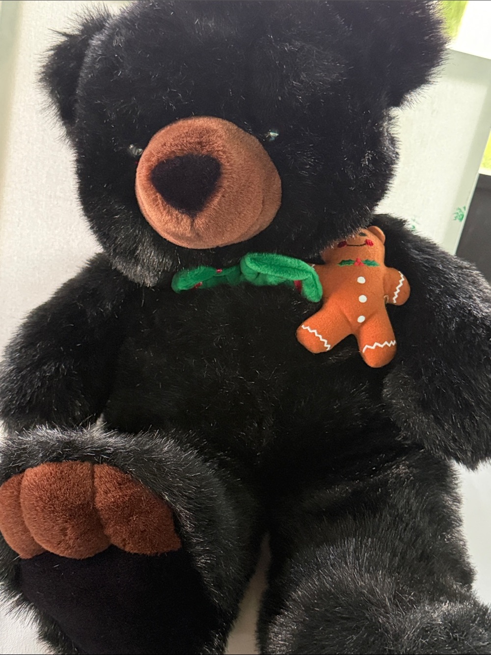 Black Plush Teddy Bear with Brown Accents and Green Bow